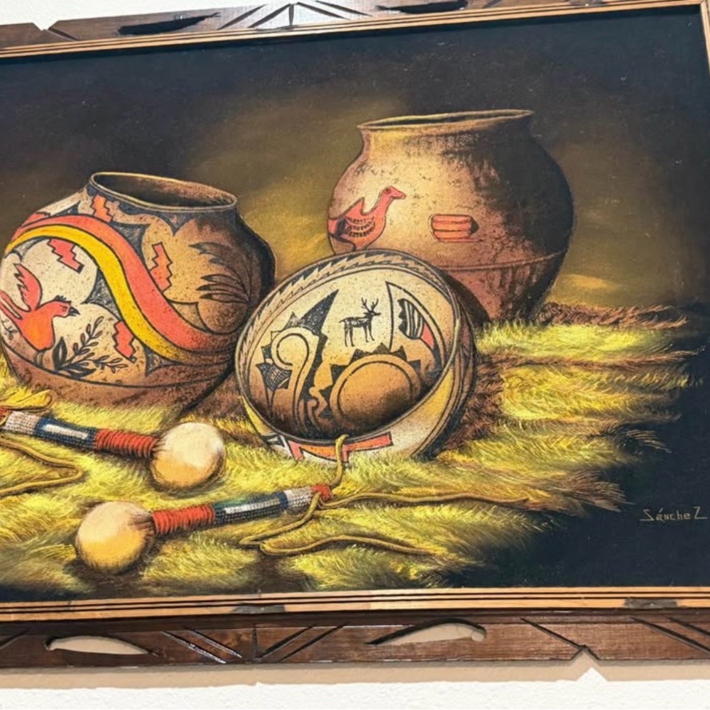 The image is of an original Native American sand art painting by an artist named